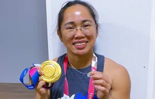 Filipina weightlifter Hidilyn Diaz proudly displays her Olympics gold medal and the Miraculous Medal, a devotional medallion depicting the Virgin Mary. Hidilyn Diaz's Instagram Stories